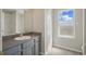 Bright bathroom featuring a vanity with gray cabinets, neutral walls, and window providing natural light at 4411 Great Harbor Ln, Kissimmee, FL 34746