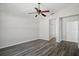 Neutral bedroom with a ceiling fan, modern flooring, and a view of a closet door at 4411 Great Harbor Ln, Kissimmee, FL 34746