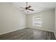 Bright bedroom featuring wood-look floors and a vaulted ceiling with a ceiling fan at 4411 Great Harbor Ln, Kissimmee, FL 34746