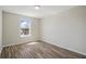Bright bedroom featuring sleek flooring and a large window at 4411 Great Harbor Ln, Kissimmee, FL 34746