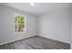 Bright, airy bedroom with hardwood floors and a large window, perfect for relaxation and comfort at 4411 Great Harbor Ln, Kissimmee, FL 34746