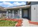 Charming front porch featuring white railings and colorful landscaping at 4411 Great Harbor Ln, Kissimmee, FL 34746