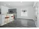 Bright, modern kitchen features gray cabinetry, stainless steel appliances, and a bar area with stylish stools at 4411 Great Harbor Ln, Kissimmee, FL 34746