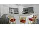 Eat-in kitchen featuring gray cabinetry, stainless steel appliances, mosaic backsplash, and barstool seating at 4411 Great Harbor Ln, Kissimmee, FL 34746