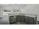 Bright, open kitchen featuring a stainless steel dishwasher, double sinks, and a breakfast bar at 4411 Great Harbor Ln, Kissimmee, FL 34746