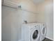 Well-lit laundry room with a washer, dryer, and wire shelving for ample storage space at 4411 Great Harbor Ln, Kissimmee, FL 34746