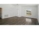 Bright living room with laminate flooring, a large window, and neutral paint at 4411 Great Harbor Ln, Kissimmee, FL 34746