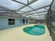 Inviting screened-in pool area features a kidney-shaped pool and ample patio space, ideal for relaxation at 4411 Great Harbor Ln, Kissimmee, FL 34746