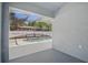 A glimpse of a private screened-in swimming pool area, as seen from inside the home at 4411 Great Harbor Ln, Kissimmee, FL 34746