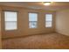 Spacious bedroom with neutral carpet and three windows allowing natural light at 4653 Marcos Cir, Kissimmee, FL 34758