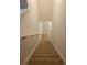 Carpeted stairs with a white handrail at 4653 Marcos Cir, Kissimmee, FL 34758