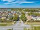 Neighborhood entrance featuring landscaped medians and community signage, surrounded by well-maintained homes and a tranquil lake at 4842 Rockvale Dr, Kissimmee, FL 34758