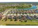 An aerial view of a residential neighborhood with a scenic lake and lush green surroundings, offering a serene community setting at 4842 Rockvale Dr, Kissimmee, FL 34758