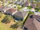 Aerial view of the home's backyard featuring a patio, and large backyard with mature trees at 4842 Rockvale Dr, Kissimmee, FL 34758