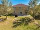 Back exterior of the home featuring a patio, basketball hoop, grill, and large backyard at 4842 Rockvale Dr, Kissimmee, FL 34758