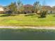 Expansive backyard with lush green grass, mature trees, and a serene waterfront view at 4842 Rockvale Dr, Kissimmee, FL 34758