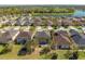 Aerial view of the home's backyard with a lake view, landscaping, well maintained yard, and mature trees at 4842 Rockvale Dr, Kissimmee, FL 34758
