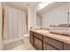 Neutral bathroom with single sink vanity, toilet, and tiled shower behind a curtain at 4842 Rockvale Dr, Kissimmee, FL 34758