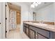 Bathroom featuring double sinks, a large mirror, and a shower with decorative curtain at 4842 Rockvale Dr, Kissimmee, FL 34758