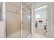 Bathroom featuring a tiled shower with glass door and a walk-in closet at 4842 Rockvale Dr, Kissimmee, FL 34758