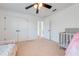 Bright bedroom with a ceiling fan and double door closet at 4842 Rockvale Dr, Kissimmee, FL 34758