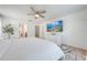 Bright bedroom featuring neutral walls, a ceiling fan, and an en-suite bath at 4842 Rockvale Dr, Kissimmee, FL 34758