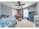 Cozy bedroom with carpet flooring and a ceiling fan, perfect for a room at 4842 Rockvale Dr, Kissimmee, FL 34758