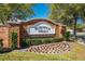 Welcoming entrance sign for Hammock Trails, a deed-restricted community with professionally landscaped greenery and a brick facade at 4842 Rockvale Dr, Kissimmee, FL 34758