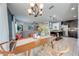 Bright dining area with wood table, chandelier, and views of the modern kitchen and inviting living room at 4842 Rockvale Dr, Kissimmee, FL 34758