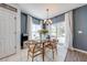 Bright dining room with modern chandelier, neutral paint, and sliding glass doors to the backyard at 4842 Rockvale Dr, Kissimmee, FL 34758