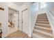 Bright entryway featuring wood floors, a carpeted staircase, and a view into a bedroom with neutral tones at 4842 Rockvale Dr, Kissimmee, FL 34758