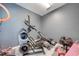 Cozy exercise room featuring workout equipment, an elliptical machine, a weight bench, and free weights for a complete workout at 4842 Rockvale Dr, Kissimmee, FL 34758