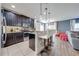 Stylish kitchen with dark wood cabinets, stainless appliances, stone backsplash and pendant lighting at 4842 Rockvale Dr, Kissimmee, FL 34758