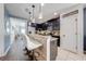 Modern kitchen featuring a breakfast bar, stainless steel appliances, and dark cabinetry, ideal for casual dining at 4842 Rockvale Dr, Kissimmee, FL 34758