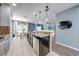 Open concept kitchen with stainless steel appliances, a central island, and views into the dining and living areas at 4842 Rockvale Dr, Kissimmee, FL 34758