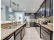 Well-appointed kitchen featuring dark cabinetry, stainless steel appliances, granite countertops and tiled backsplash at 4842 Rockvale Dr, Kissimmee, FL 34758