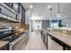 Modern kitchen with stainless steel appliances, stone backsplash, granite countertops and white tile flooring at 4842 Rockvale Dr, Kissimmee, FL 34758