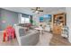 Living area features a gray sectional sofa, accent wall with a TV, bright window, and is styled with bright pops of color at 4842 Rockvale Dr, Kissimmee, FL 34758