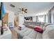 Spacious living room that flows into dining room and kitchen, featuring a large sectional sofa and a white shag rug at 4842 Rockvale Dr, Kissimmee, FL 34758