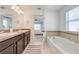 Main bathroom with double vanity, soaker tub, and a separate doorway to the bedroom at 4842 Rockvale Dr, Kissimmee, FL 34758