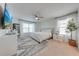Bright main bedroom with carpet, a ceiling fan, a large bed, and ensuite bathroom at 4842 Rockvale Dr, Kissimmee, FL 34758