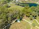 Aerial view of a park with a small lake, playground, open field, and multiple walking paths at 4842 Rockvale Dr, Kissimmee, FL 34758