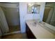 Bright bathroom featuring a walk-in shower, neutral tile, and large vanity at 5004 Laguna Bay Cir # 54, Kissimmee, FL 34746