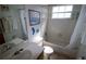 Neutral bathroom featuring a tub, toilet, and sink at 5004 Laguna Bay Cir # 54, Kissimmee, FL 34746