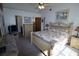 Bright bedroom featuring a vaulted ceiling, ceiling fan, and adjoining Primary bath at 5004 Laguna Bay Cir # 54, Kissimmee, FL 34746