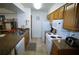 An open kitchen featuring wood cabinetry, stone countertops, and tiled floors at 5004 Laguna Bay Cir # 54, Kissimmee, FL 34746