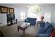 Comfortable living room featuring an oversized window, modern furnishings, and neutral colored carpeting at 5004 Laguna Bay Cir # 54, Kissimmee, FL 34746