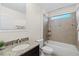 Well-lit bathroom featuring granite countertop, dark cabinets, and a shower-tub combo at 5201 Lake Hinden Cv, St Cloud, FL 34771