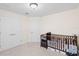Bright bedroom with double doors and a changing table beside a crib for comfort and convenience at 5201 Lake Hinden Cv, St Cloud, FL 34771