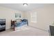 This bedroom is well lit and decorated with an ocean themed painting hung above a bed at 5201 Lake Hinden Cv, St Cloud, FL 34771